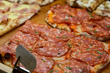 Authentic Italian pizza in a restaurant display window in Rome, Italy.  Different type of traditional Roman styple pizza . 