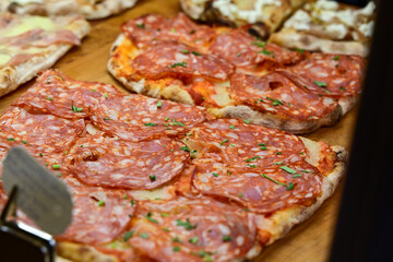 Authentic Italian pizza in a restaurant display window in Rome, Italy.  Different type of traditional Roman styple pizza . 