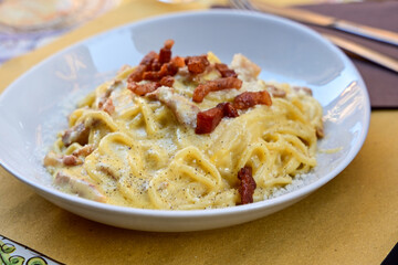 Fresh pasta    tonnarelli alla carbonara and Aperol Spritz  at  typical italian resaturant at Trastevere   neighbourhood at Rome 