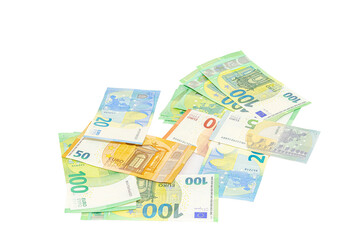 Pile of assorted euro banknotes including one hundred, fifty, twenty, ten and five euro notes scattered on a plain white background, tilted view, studio shot close-up macrophotography..