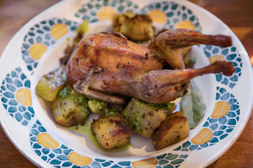 Whole oven roasted quail with garlic potatoes at a restaurant in Nice, France