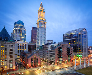 The iconic architecture of Boston in Massachusetts, USA at night showcasing the North End of the city with its skyscrapers and roadways.