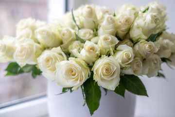 White roses arranged beautifully in a decorative vase, creating an elegant background for celebrations, anniversaries, and special occasions with floral charm and natural beauty