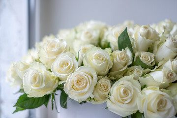 White roses arranged beautifully in a decorative bouquet, perfect for celebrations, anniversaries, or special occasions, creating an elegant floral background with soft textures