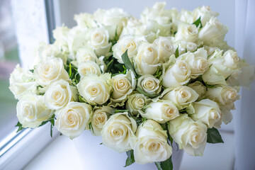 White roses arranged beautifully in a decorative bouquet, perfect for celebrations and anniversaries, creating a romantic and elegant atmosphere with floral charm