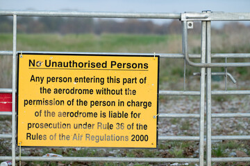 No unauthorised persons - signs warning trespassing on airport grounds is a criminal offence
