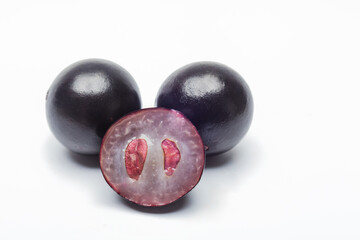 Exotic Brazilian jabuticaba fruit with visible seeds on white background