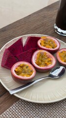 Passion fruit and dragon fruit slices served on neutral plate