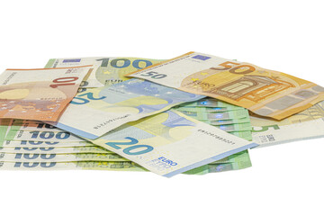 Pile of assorted euro banknotes including one hundred, fifty, twenty, ten and five euro notes scattered on a transparent background, studio shot in tilted view, close-up macrophotography.