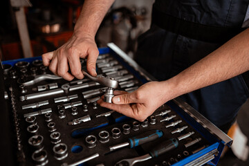 Technician organizing tools in a workshop during the day