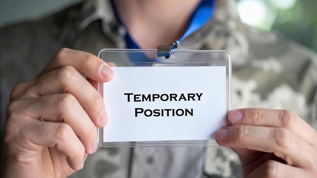 Mans temporary position badge, reflection of job uncertainty driven by labor market shortage, points to contractual employment as modern stopgap solution