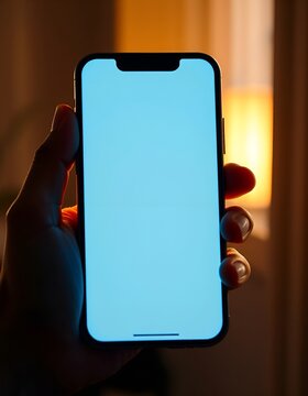 Hand holding modern smartphone with empty screen. Mobile phone mockup for app developers and designers. Ideal for showcasing digital products and mobile applications.

