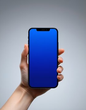 Hand holding modern smartphone with empty screen. Mobile phone mockup for app developers and designers. Ideal for showcasing digital products and mobile applications.
