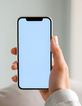 Hand holding modern smartphone with empty screen. Mobile phone mockup for app developers and designers. Ideal for showcasing digital products and mobile applications.
