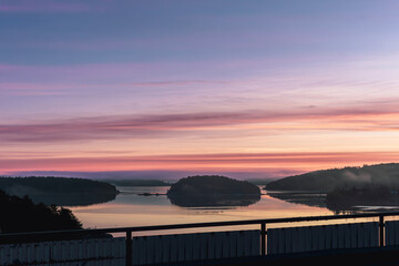 menton, cote d'azur/ france- 0919 2022 extensive scene capturing calm river islands set against lively sunset