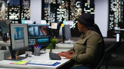 Woman video creator working on editing a movie montage project, multitasking with dual monitors. Female footage editor starting the cinematic creative process, film editing industry. Camera B.