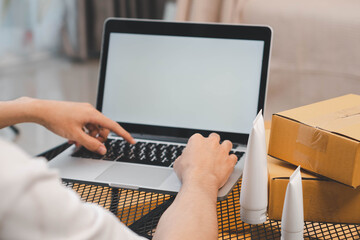 Startup small business owner packing boxes for online customer delivery. Entrepreneur managing e-commerce orders, shipping parcels, and running home-based business operations from home office.