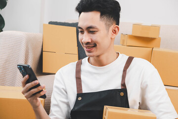 Startup small business owner packing boxes for online customer delivery. Entrepreneur managing e-commerce orders, shipping parcels, and running home-based business operations from home office.