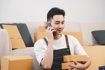 Startup small business owner packing boxes for online customer delivery. Entrepreneur managing...