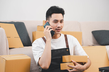 Startup small business owner packing boxes for online customer delivery. Entrepreneur managing...