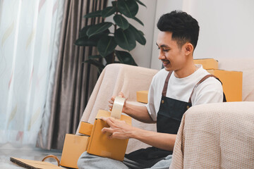 Startup small business owner packing boxes for online customer delivery. Entrepreneur managing...