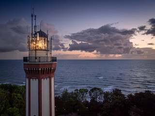Light beam from lighthouse by Sea in Poland after sunset.