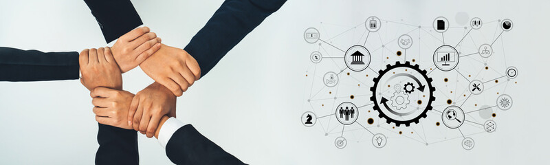 Hands of diverse individuals interlocked symbolize teamwork and collaboration in a business...