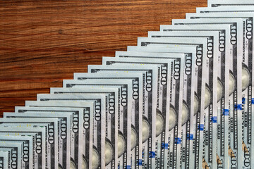 Background of many american one hundred dollar banknotes. A pile of new one hundred US dollars. Cash of hundred dollar bills, closeup