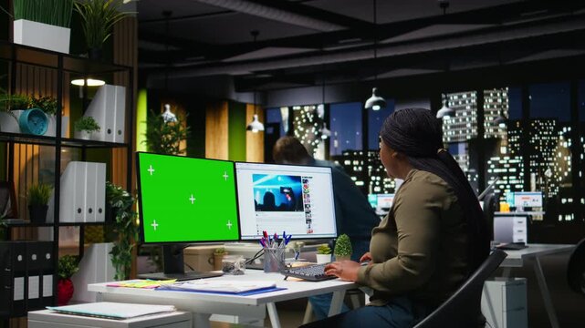 Chroma key next to production specialist checks social media platforms for reels content, boosting marketing and branding. Aligning with current media trends and monetization insights. Camera A.