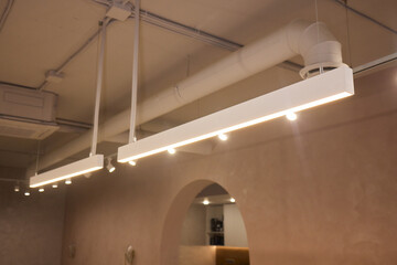 Lighting arrangement emphasizes fixtures and architectural features, Technical adjustments enhance...