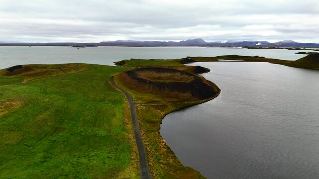 4K drone aerial footage over volcanic pseudo craters Skutustadagigar in lake Myvatn. Huge cones of pseudo craters on the Icelandic shore.