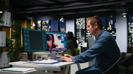 Graphic developer working with photo editing software at the office, digital media production with professional tools. Dual monitors for productivity in the graphic design industry. Camera A.