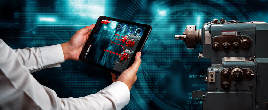 Engineer use augmented reality software in smart factory production line with automated application . Futuristic machinery in working in concept of Industry 4.0 or 4th industrial revolution.