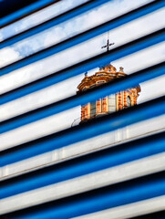 Dome of San Luis de los Franceses Church seen through shutters
