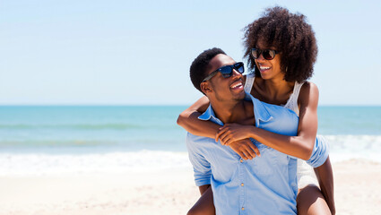 Joyful african american couple shares a playful moment on the beach during summer holidays, with sunny skies and gentle waves in the background. They are embracing and smiling happily. Generative AI.