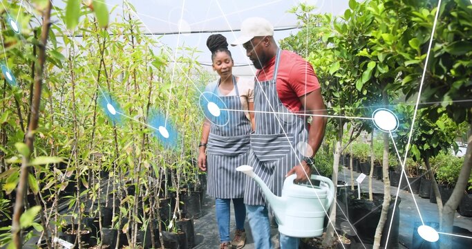 Watering garden staff wearing striped aprons tending plants in nursery with blue can and AR overlay