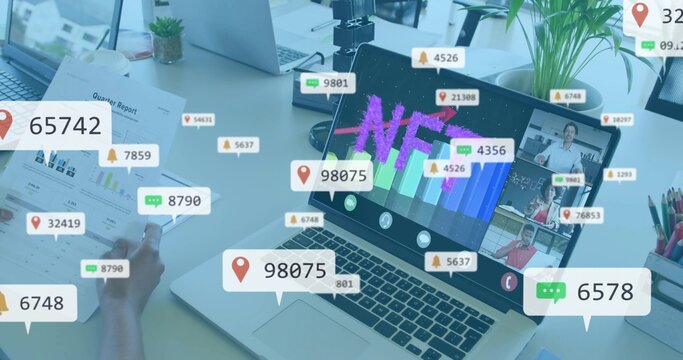 Displaying main laptop showing NFT chart at office desk, team in shirts holding printed report - Powered by Adobe