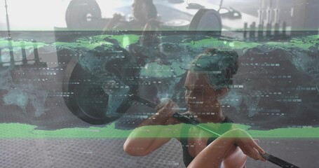 Lifting mid-adult woman in black tank top holding loaded barbell at gym with world map overlay