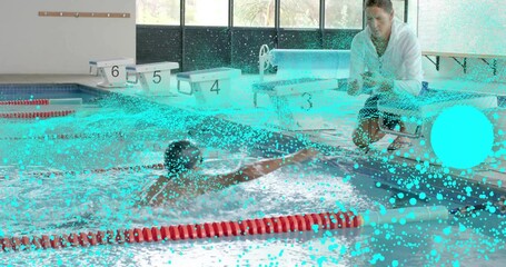 Reaching swimmer in swimwear and goggles at pool, coach in white holding bright ball, lanes