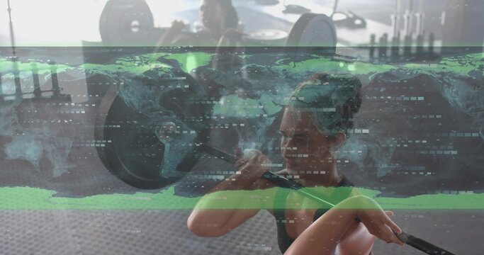 Lifting mid-adult woman in black tank top holding loaded barbell at gym with world map overlay