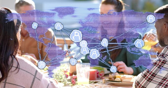 Sharing six adults wearing casual layered clothing dining at outdoor patio, with world map overlay