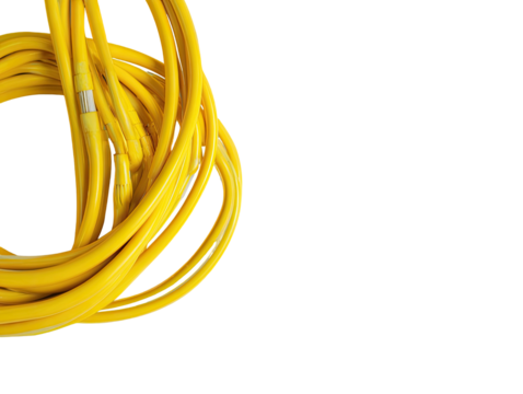 Coiled yellow cord pile against stark black background.