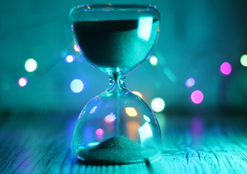 hourglass sand glass on the table as a symbol of passing time	
