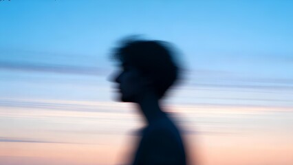 Silhouette of a moving person against dreamy colorful blurred light background, artistic abstract motion blur photography symbolizing energy, contrast, and expressive modern art concept in vibrant
