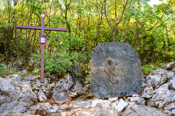Station X: Jesus is stripped of his garments (Division of robes). The Way of the Cross on Mount Križevac (the Cross Mountain) in Medjugorje.