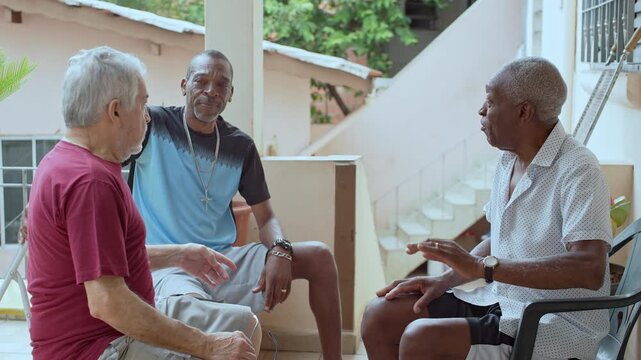 Three Elderly Men Sitting On Porch Laughing And Chatting Together In Relaxed Social Moment Of Friendship And Joy, Fundamental Moments To Prolong Life At Advanced Age