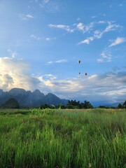 Sunset Over Green Rice Fields and Limestone Mountains in Vang Vieng Laos