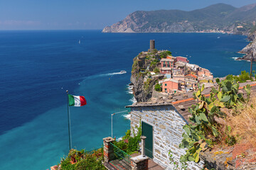 Cliffside view of Vernazza with coastal buildings and sea in Liguria, Italy