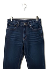 Dark blue denim trousers suspended by a metal hanger on a white background highlighting the garments top half with pockets and button closure