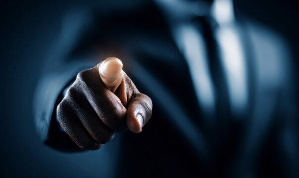 A man in a suit points directly toward the viewer with a focused intensity.